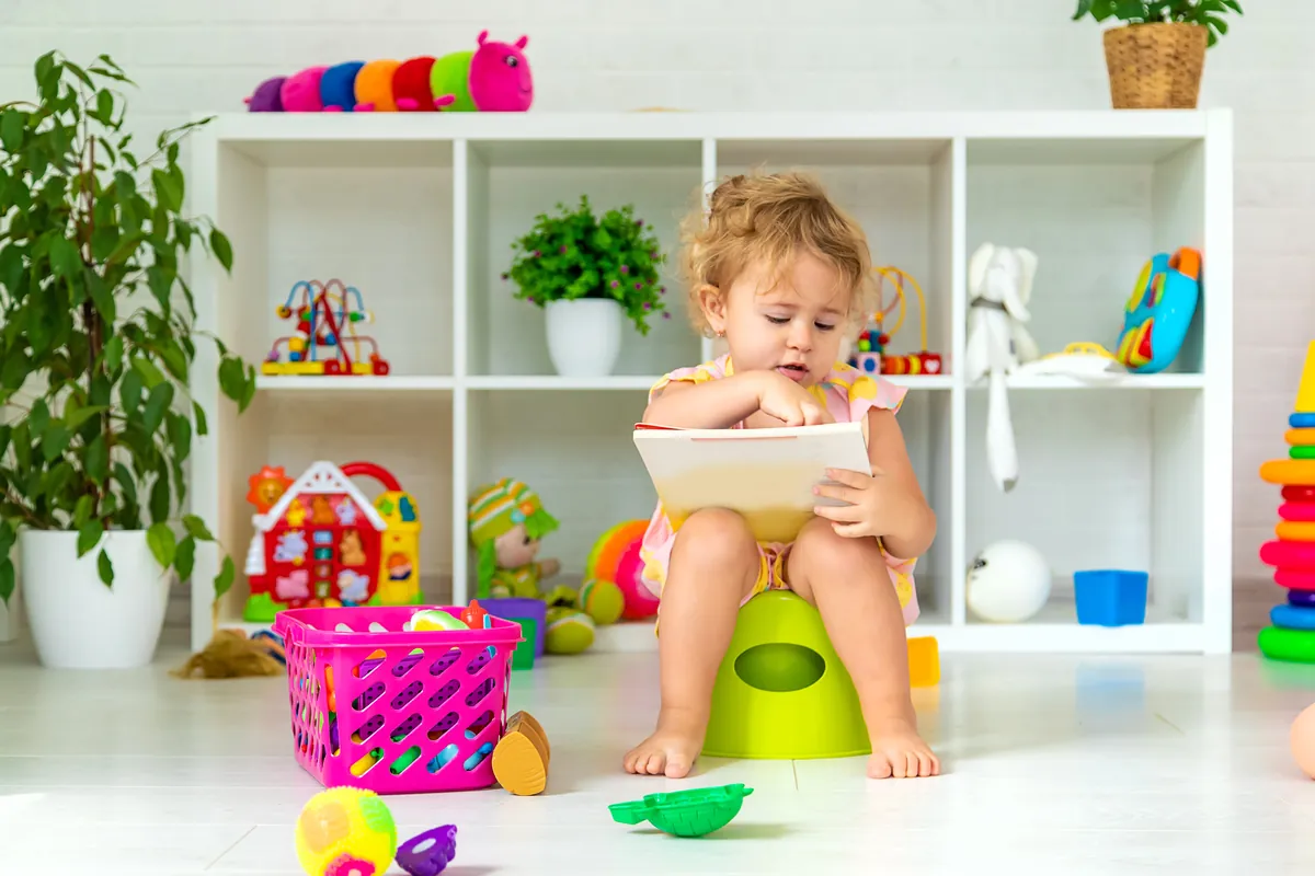 Toddler sitting on a colorful potty