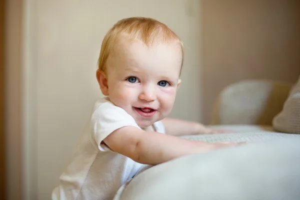 When do babies stand up?